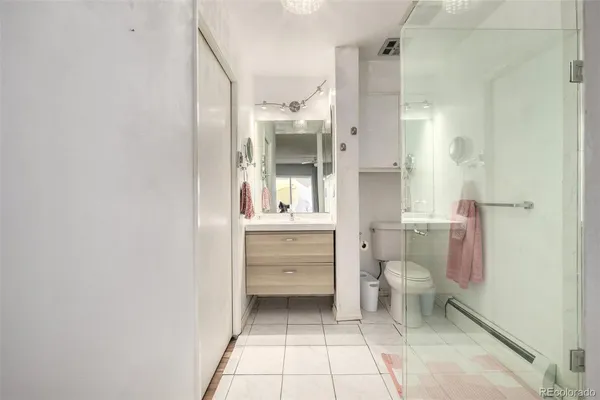 a bathroom with a sink a toilet and a shower