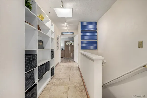 a hallway with cabinets and stairs
