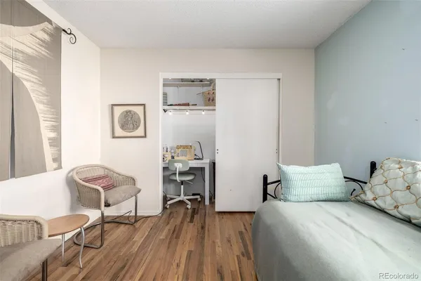 a bedroom with a bed and chair