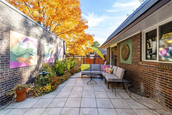 a backyard of a house with outdoor seating