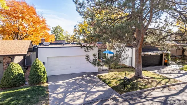 a view of a backyard house with large tree