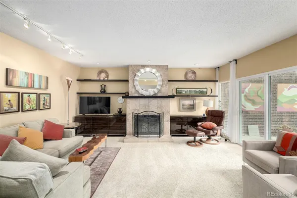 a living room with furniture flat screen tv and a fireplace