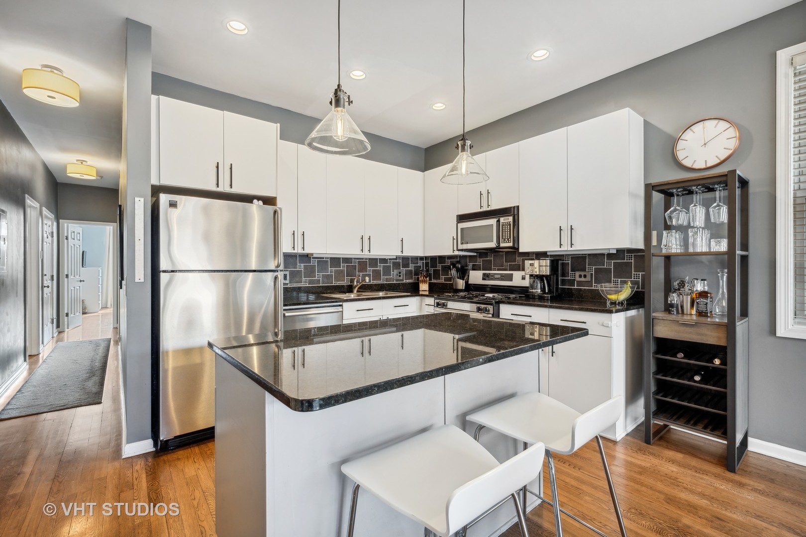 2123 West Rice Street, Unit 3W Chicago, IL 60622 - Photo 8 of 17 a kitchen with stainless steel appliances granite countertop a refrigerator a stove and a wooden floors