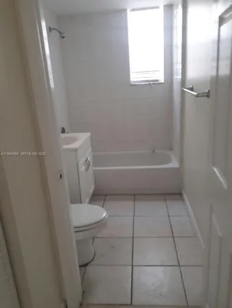 a bathroom with a toilet a sink a vanity and mirror