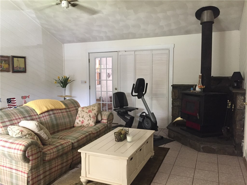 10 Duffield Road Bristol, RI 02809 - Photo 17 of 37 Family room with wood burning stove and access to screened in porch area.