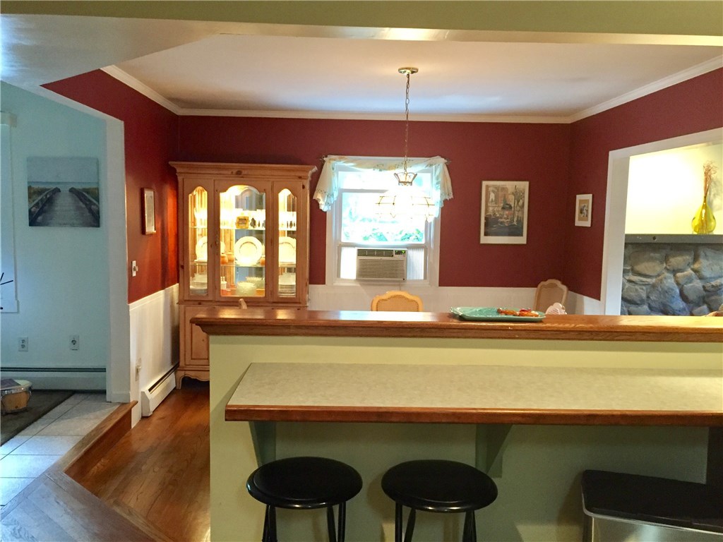 10 Duffield Road Bristol, RI 02809 - Photo 7 of 37 Pleasant sun filled tiled Kitchen and open dining room with hardwood floors.