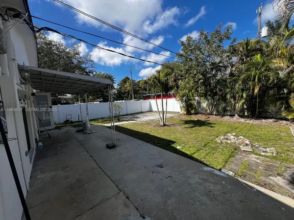a view of a backyard with a tree