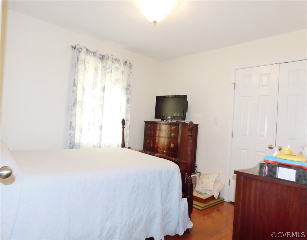 566 Fanny White Road Buckingham, VA 23921 - Photo 14 of 21 a bedroom with a bed closet and a flat tv screen on a dresser
