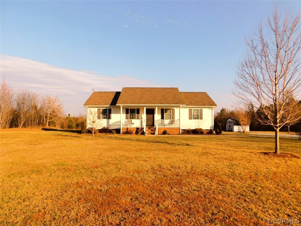 566 Fanny White Road Buckingham, VA 23921 - Photo 2 of 21 a front view of house with yard and ocean