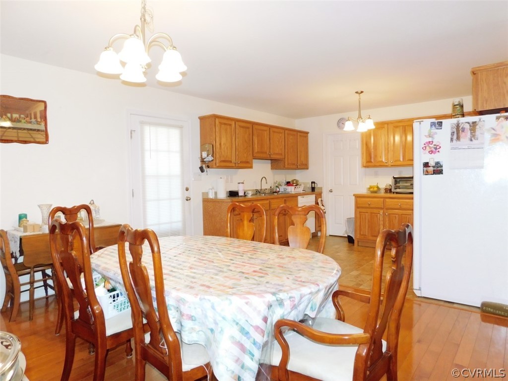 566 Fanny White Road Buckingham, VA 23921 - Photo 5 of 21 a kitchen with stainless steel appliances granite countertop a dining table and chairs with wooden floor