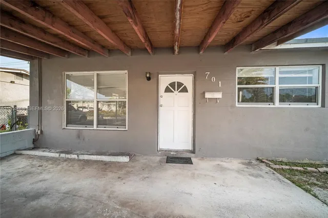 a view of a livingroom with wooden floor and windows