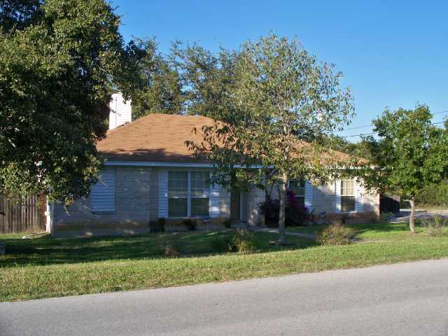 a view of a house with a tree and plants