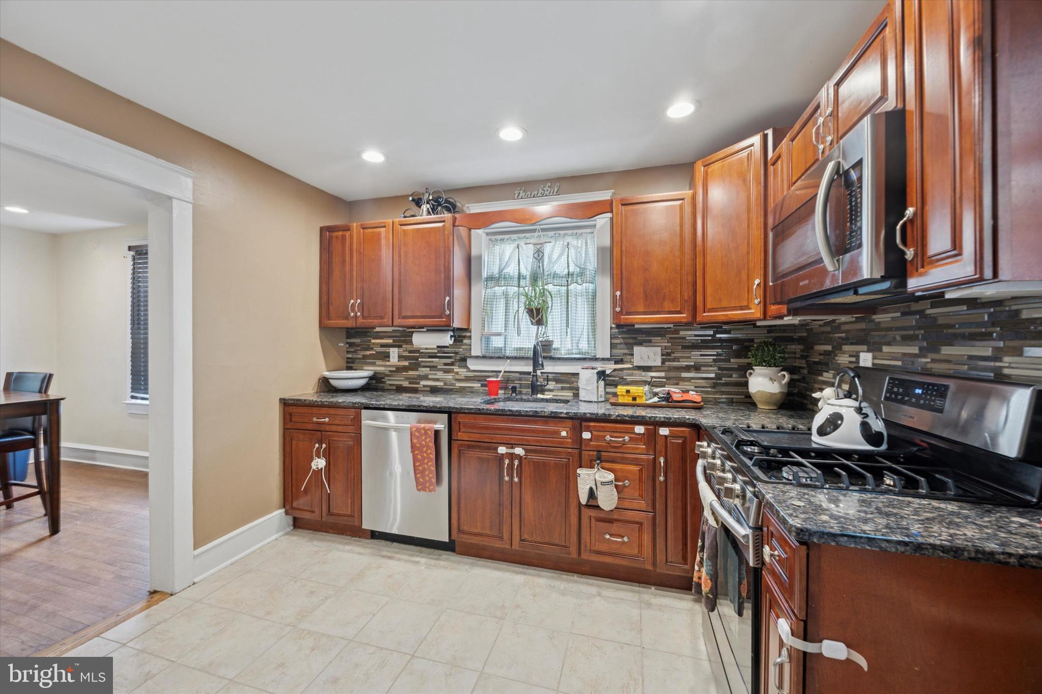 265 West Ridley Avenue Ridley Park, PA 19078 - Photo 8 of 25 a kitchen with stainless steel appliances granite countertop wooden cabinets a sink and dishwasher