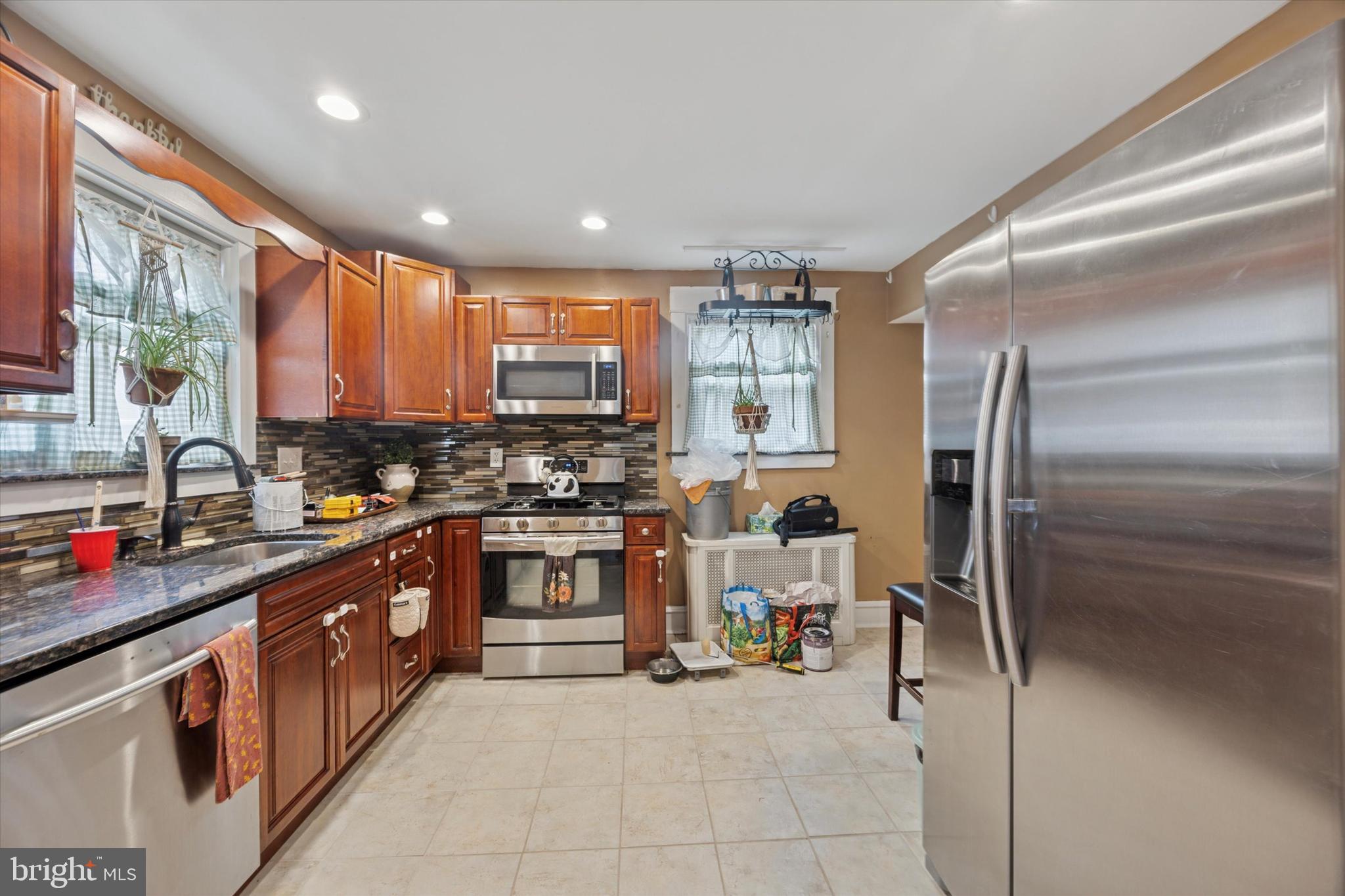 265 West Ridley Avenue Ridley Park, PA 19078 - Photo 9 of 25 a kitchen with stainless steel appliances granite countertop a sink stove and refrigerator