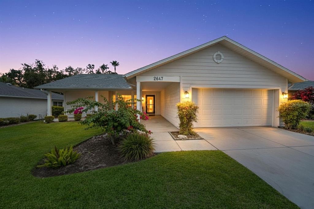 2647 Royal Ridge Drive Spring Hill, FL 34606 - Photo 2 of 73 a front view of a house with a yard and garage