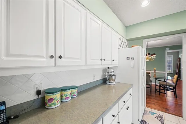 a view of a dining room with furniture wooden floor and chandelier