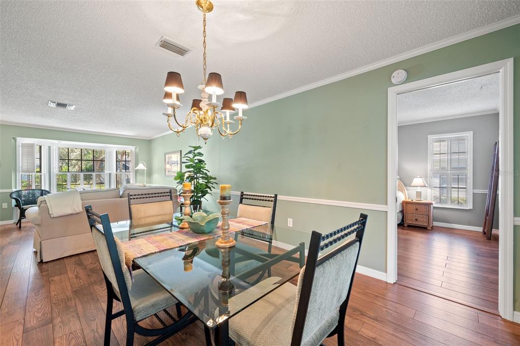 2647 Royal Ridge Drive Spring Hill, FL 34606 - Photo 35 of 73 a view of a dining room with furniture wooden floor and chandelier