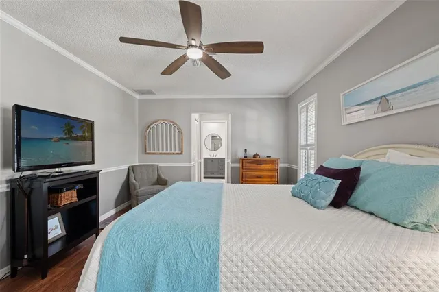 a living room with furniture a flat screen tv and a window