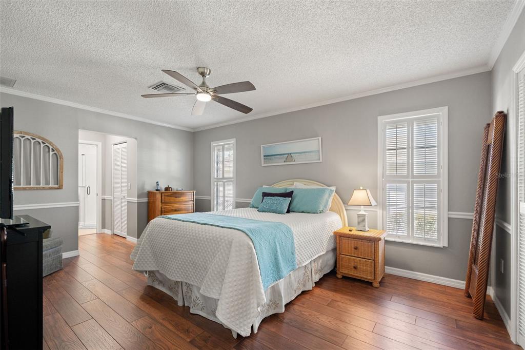 2647 Royal Ridge Drive Spring Hill, FL 34606 - Photo 44 of 73 a bedroom with a bed and a chandelier