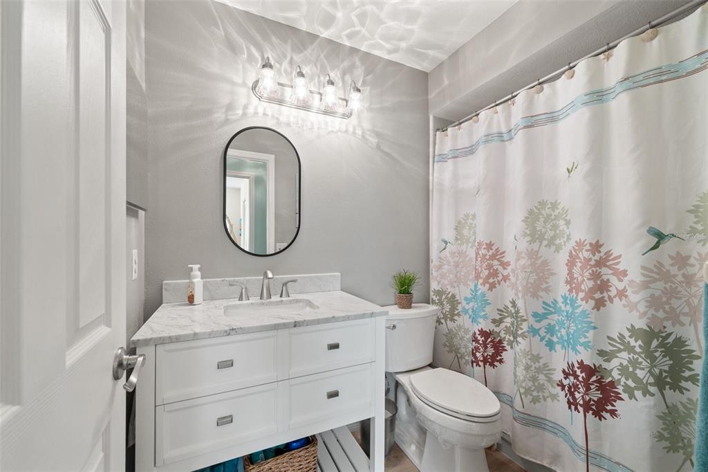 2647 Royal Ridge Drive Spring Hill, FL 34606 - Photo 45 of 73 a bathroom with a toilet sink and mirror