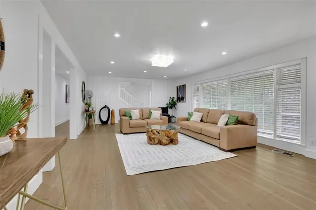 a living room with furniture and wooden floor