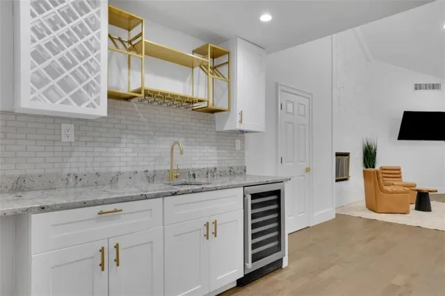 a kitchen with a sink cabinets and appliances