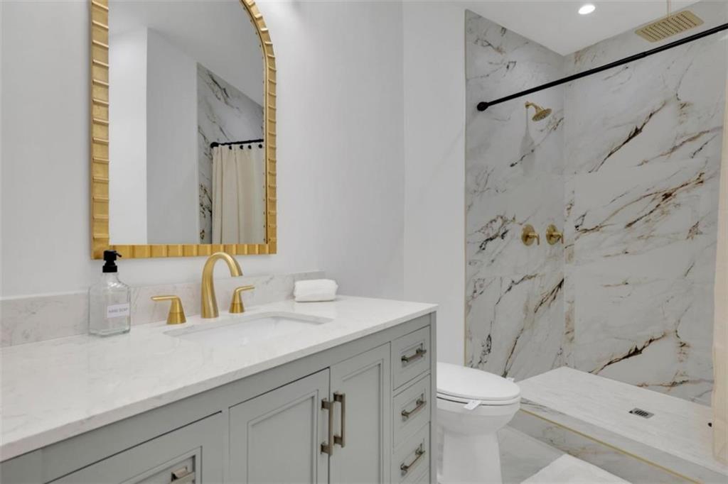 3018 West Pine Valley Road Northwest Atlanta, GA 30305 - Photo 16 of 47 a bathroom with a sink a toilet and a mirror