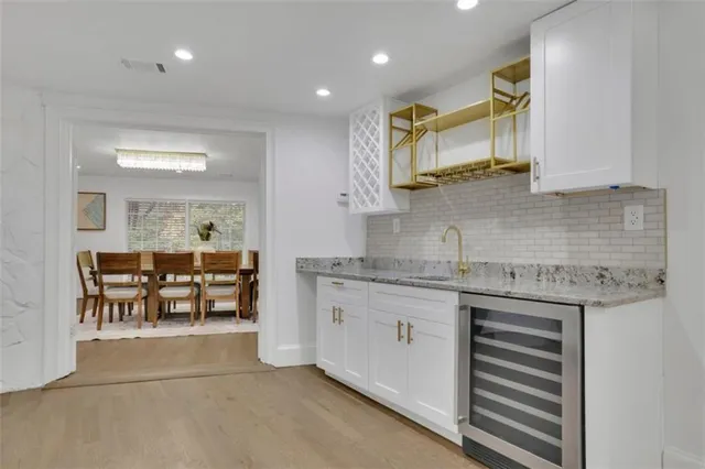 a kitchen with granite countertop cabinets a sink and a stove top oven