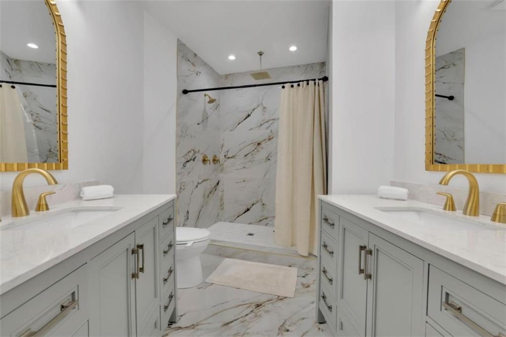 3018 West Pine Valley Road Northwest Atlanta, GA 30305 - Photo 18 of 47 a bathroom with a sink a toilet and shower