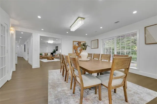 a dining room with furniture and a floor to ceiling window