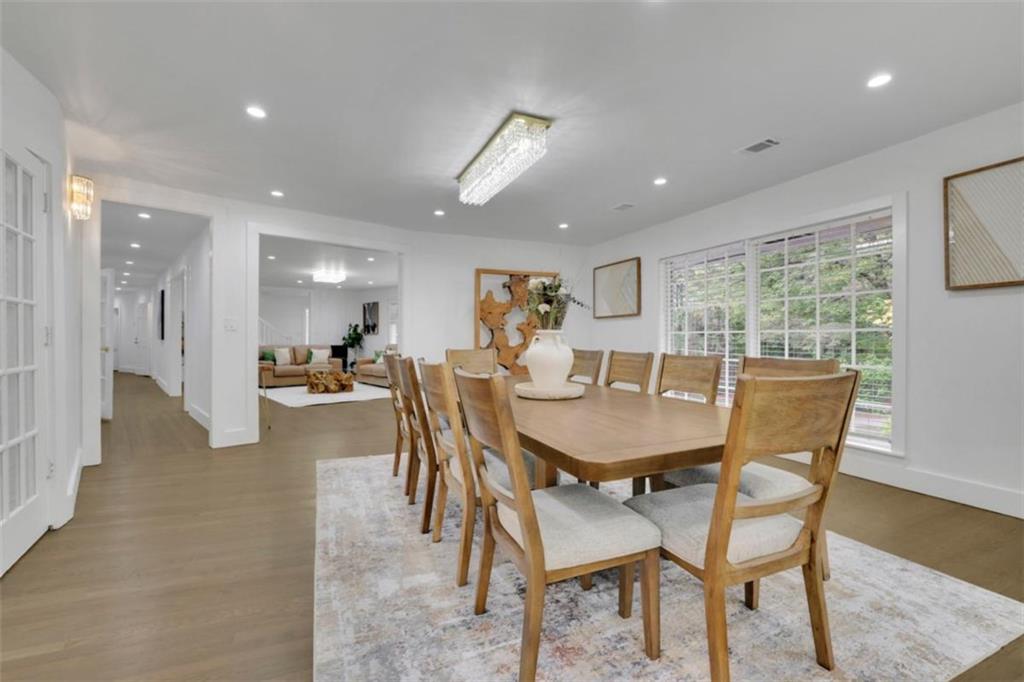 3018 West Pine Valley Road Northwest Atlanta, GA 30305 - Photo 26 of 47 a dining room with furniture and a floor to ceiling window