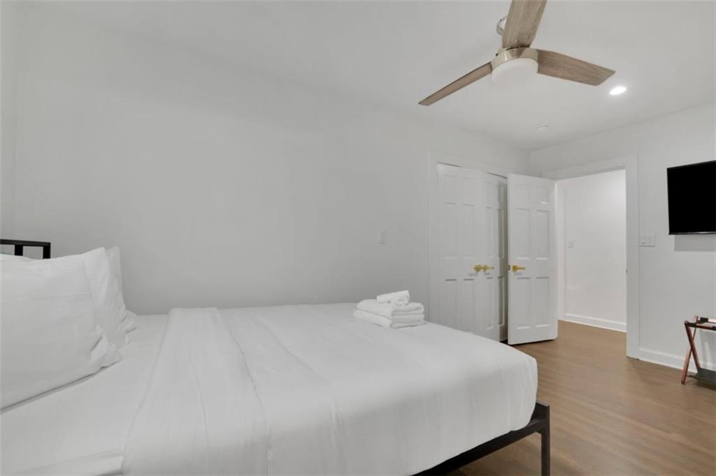 3018 West Pine Valley Road Northwest Atlanta, GA 30305 - Photo 29 of 47 a bedroom with a bed and a flat screen tv