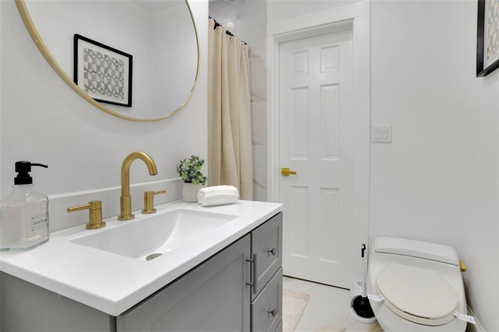 3018 West Pine Valley Road Northwest Atlanta, GA 30305 - Photo 33 of 47 a bathroom with a sink toilet and vanity