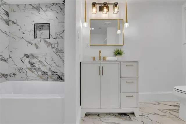 a bathroom with a bathtub sink and toilet