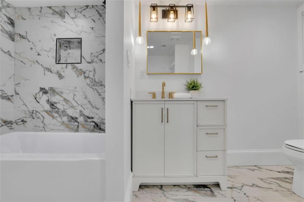 3018 West Pine Valley Road Northwest Atlanta, GA 30305 - Photo 34 of 47 a bathroom with a bathtub sink and toilet