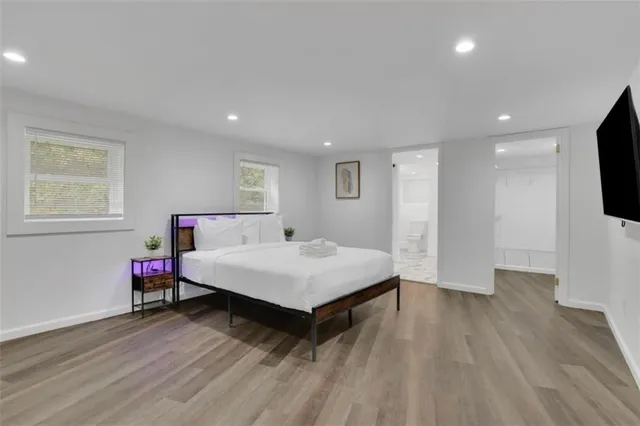 a room with a bed and a flat screen tv