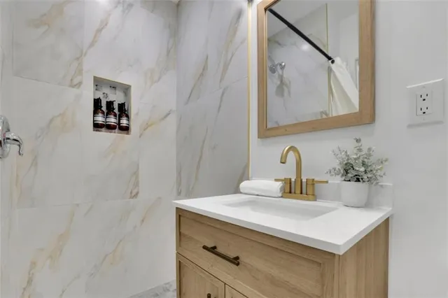a bathroom with a sink vanity and a mirror