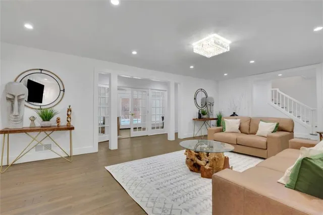 a living room with furniture and wooden floor