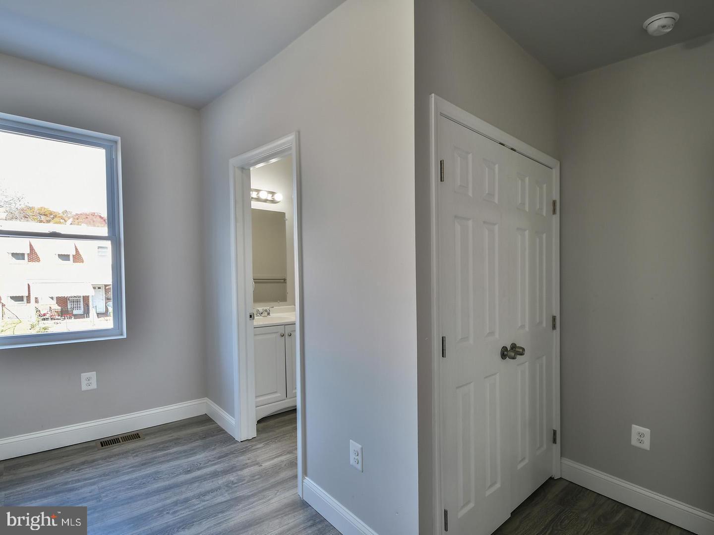 2605 Kirk Avenue Baltimore, MD 21218 - Photo 13 of 17 an empty room with wooden floor and a window