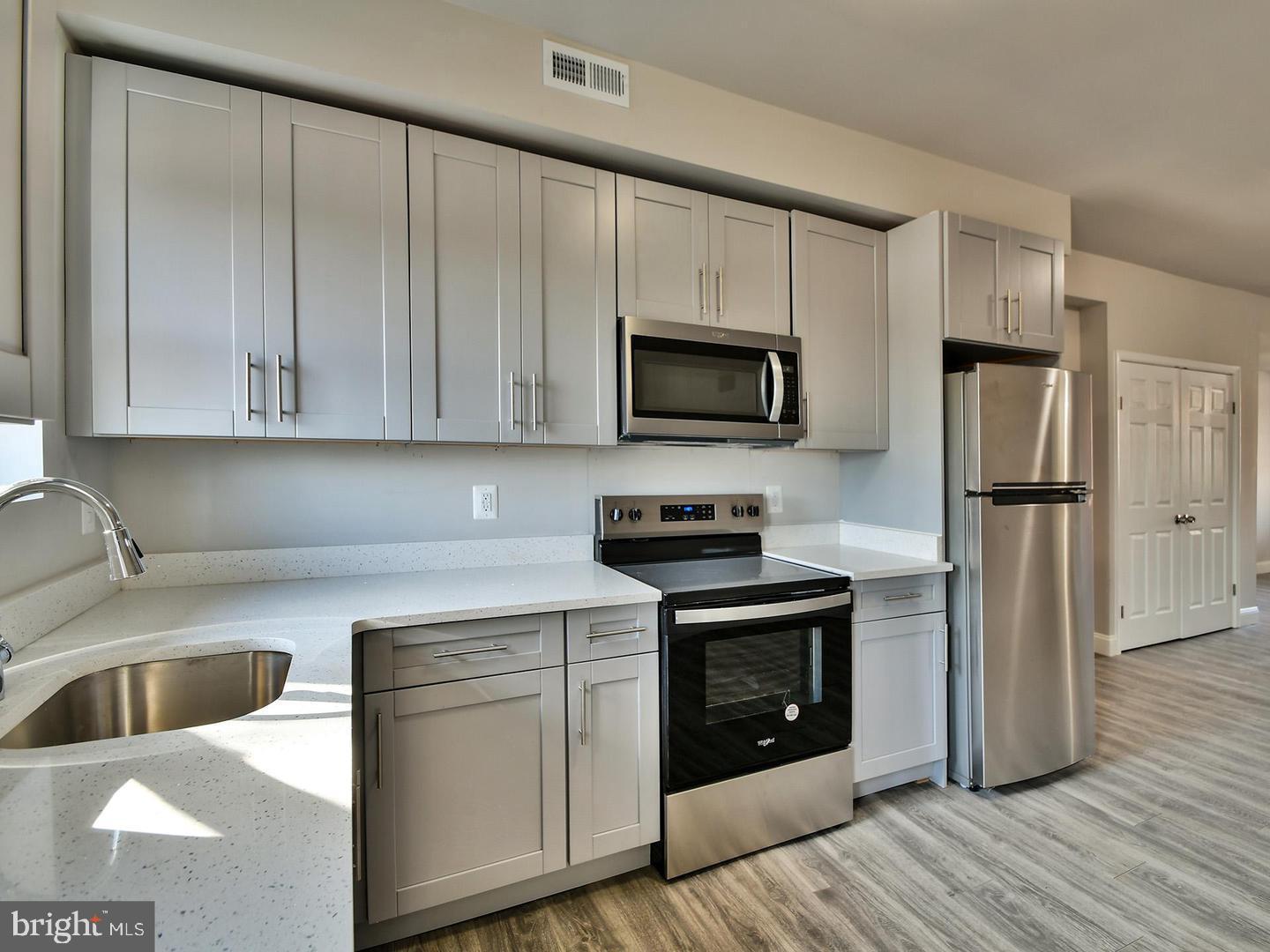 2605 Kirk Avenue Baltimore, MD 21218 - Photo 4 of 17 a kitchen with a sink stove and refrigerator