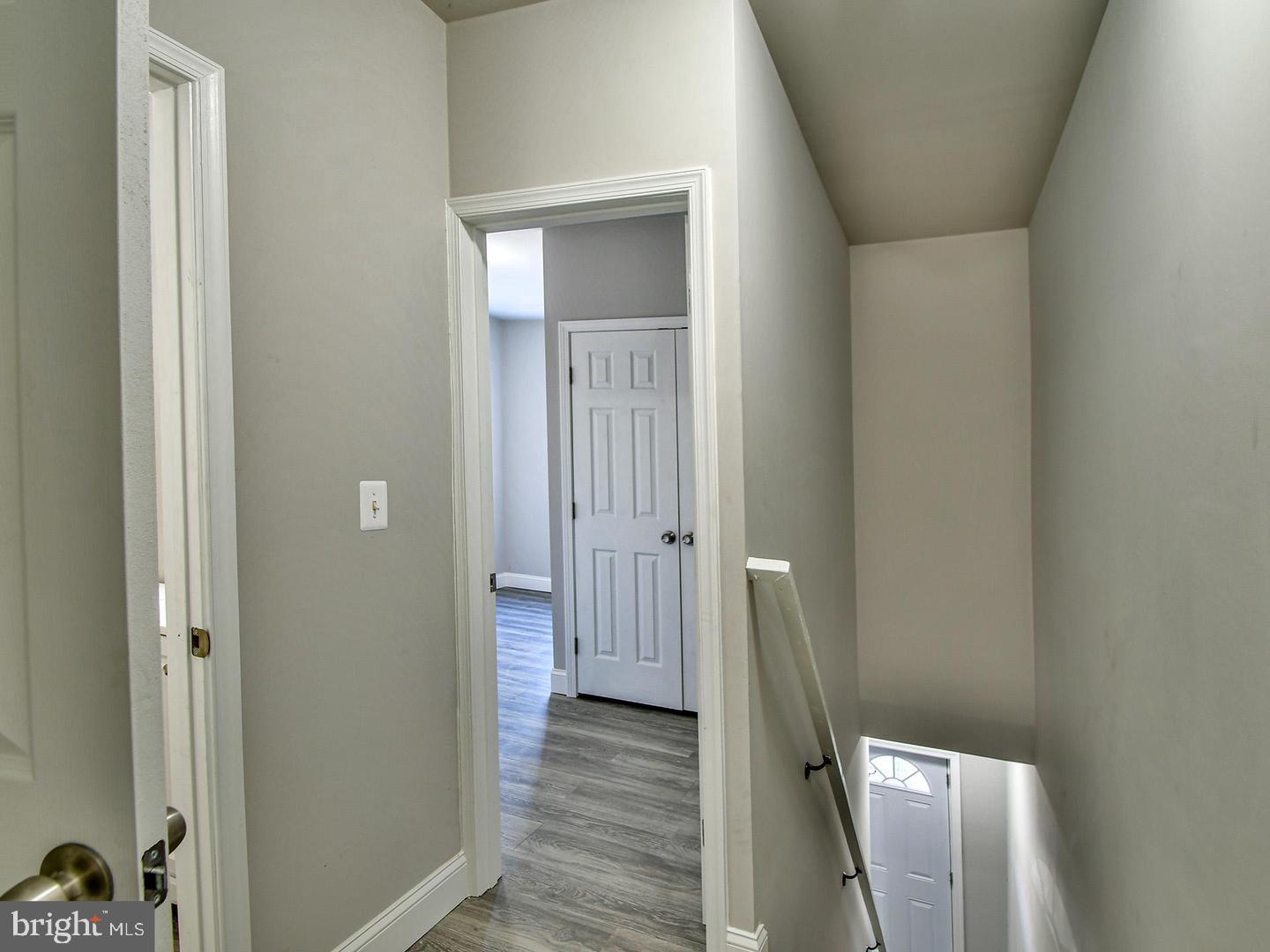 2605 Kirk Avenue Baltimore, MD 21218 - Photo 8 of 17 a view of a hallway with wooden floor and staircase