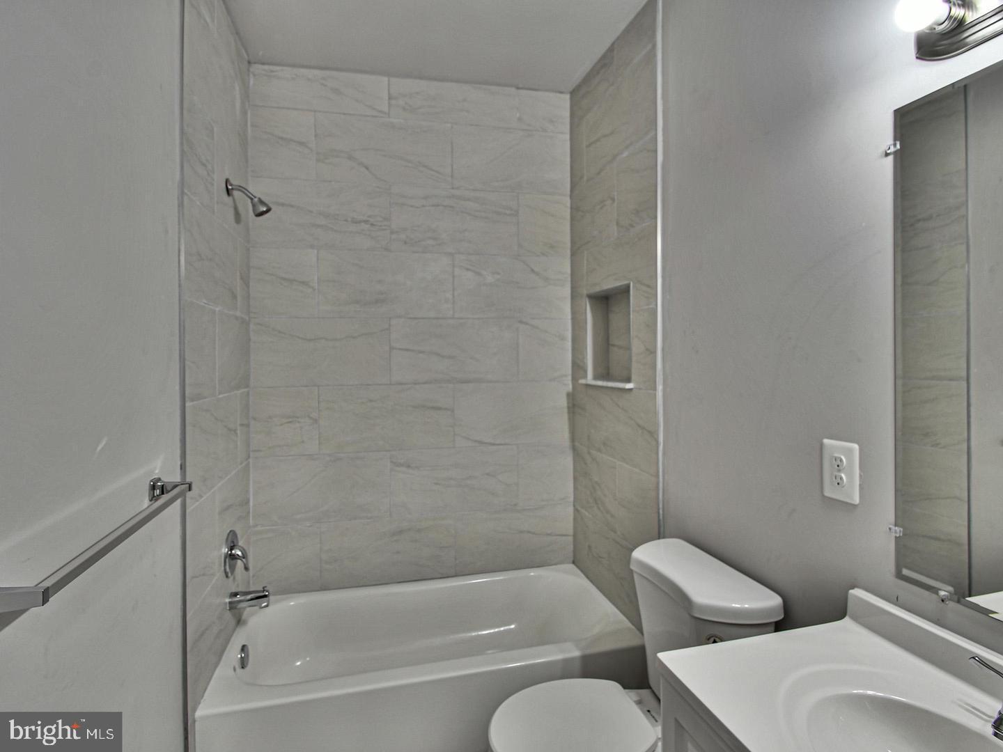 2605 Kirk Avenue Baltimore, MD 21218 - Photo 9 of 17 a bathroom with a toilet and a bath tub