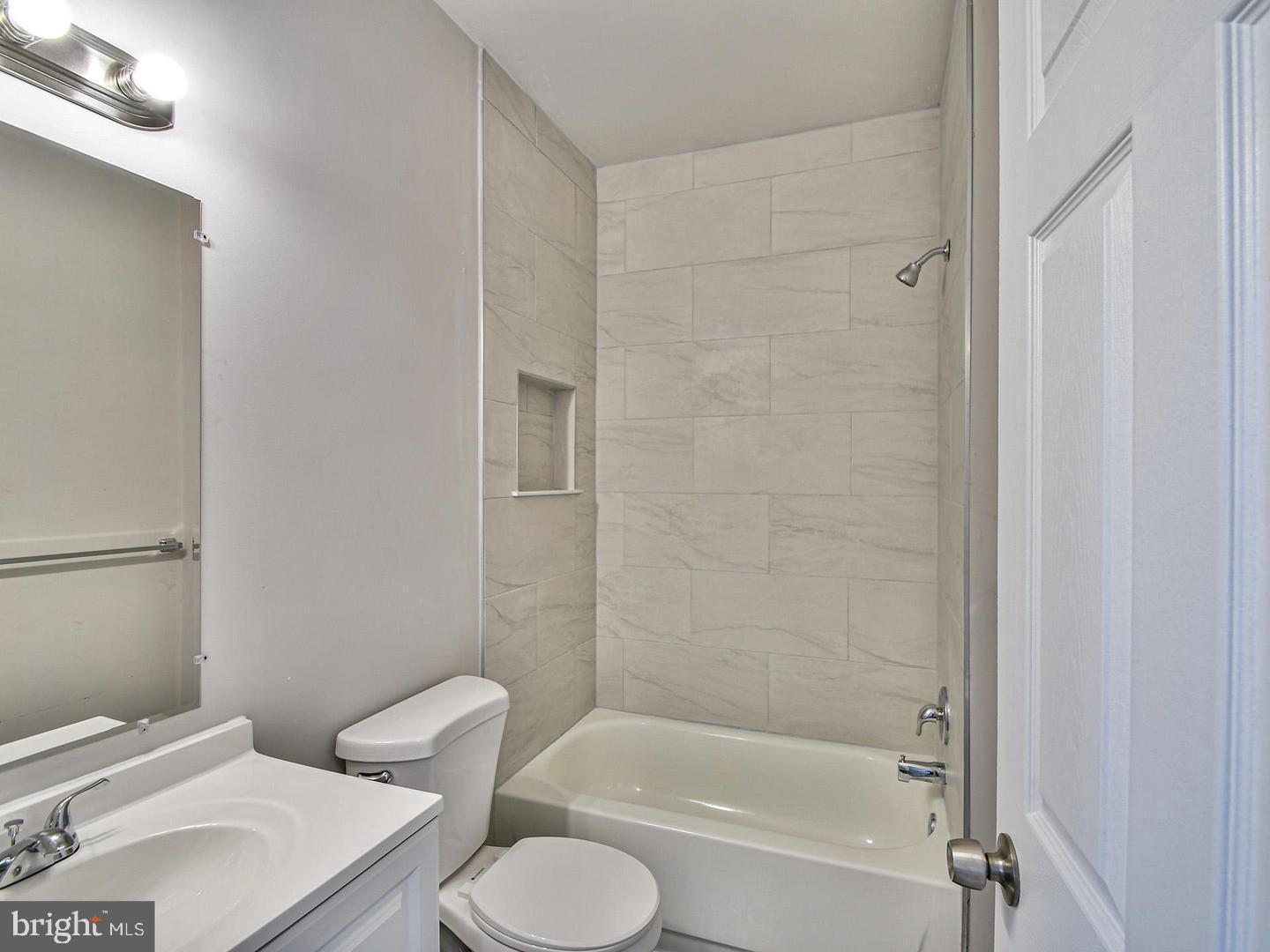 2605 Kirk Avenue Baltimore, MD 21218 - Photo 10 of 17 a white toilet sitting next to a bath tub