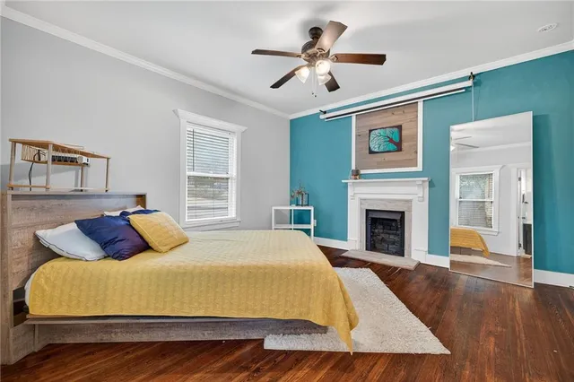 a bed sitting in a bedroom and chandelier