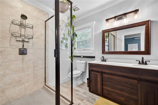 a bathroom with a double vanity sink mirror and shower