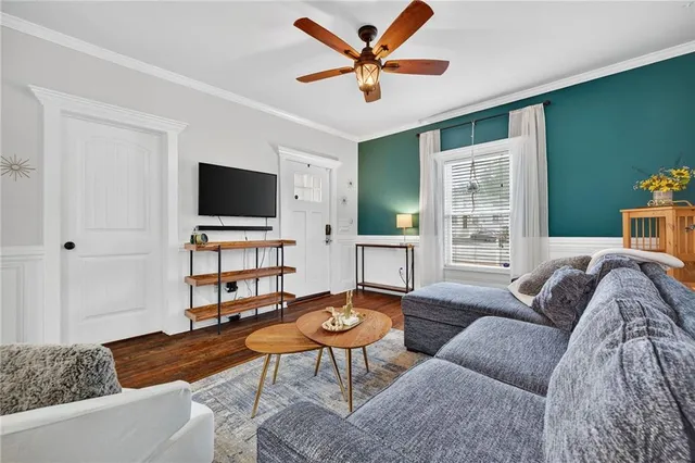 a living room with furniture and a flat screen tv