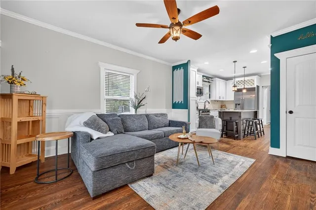a living room with furniture and a wooden floor