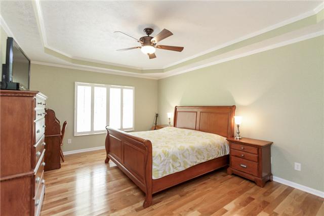 7876 Oscar Green Road Primm Springs, TN 38476 - Photo 12 of 20 19x14 master bedroom with hardwood floors, ceiling fan and trey ceiling