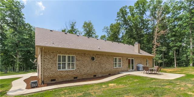 7876 Oscar Green Road Primm Springs, TN 38476 - Photo 2 of 20 Back of home with sidewalk and patio