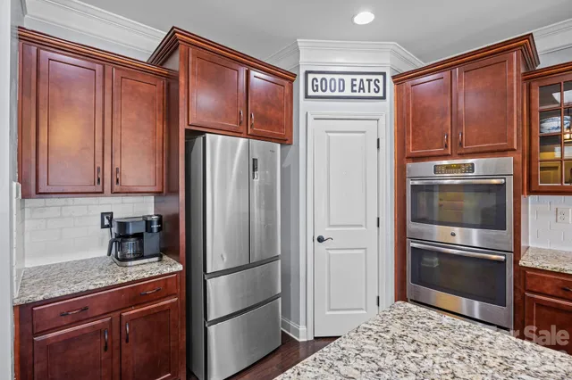 a kitchen with stainless steel appliances granite countertop a stove microwave and cabinets